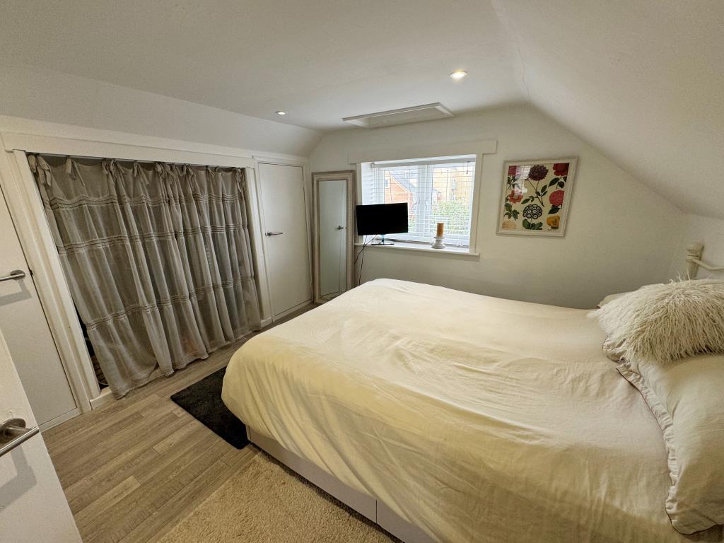 Lot: 69 - SHOP AND TWO-BEDROOM FLAT FOR INVESTMENT OR OWNER OCCUPATION - Second floor bedroom with built in storage